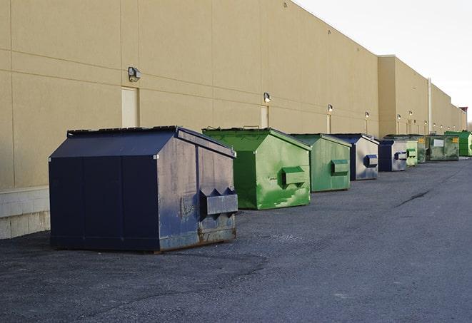 a collection of bright and vibrant dumpsters in a construction zone in Beechgrove